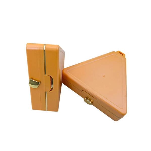 Side view of two closed triangular orange makeup compacts, cheese design empty cosmetic packaging