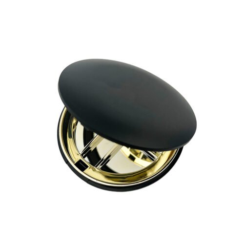 Tilted top view of partially open black matte round empty eyeshadow palette packaging