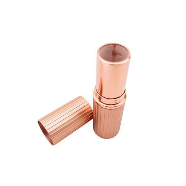 st-ls-001-02 The appearance of a rose gold striped lipstick tube when its cap is being opened.