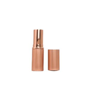 Ribbed Lipstick Tube – the photographed cylindrical case has a rose-gold appearance with closely spaced vertical ribs