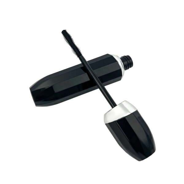 st-mc-007-06 Cross display of empty faceted mascara tube, black glossy bottle and cap with mascara brush on white background