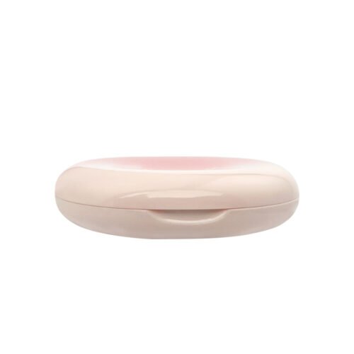 Side profile view of closed glossy gradient pink off-white oval powder compact with front push latch