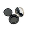 Round empty powder compact fully opened, showing built-in mirror, glossy black powder tray and separate inner cover