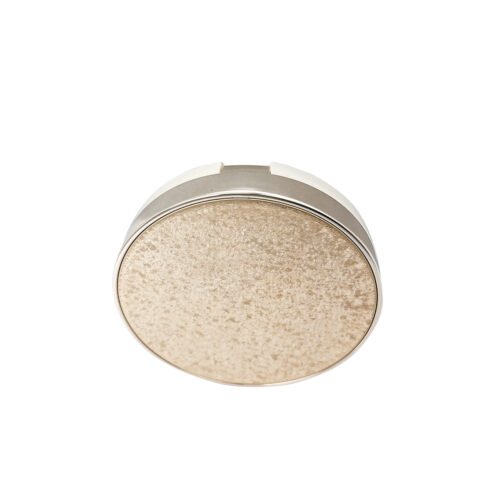 Glitter Lid Cushion Compact – the round case has a glitter-like textured top and a pale metallic-looking perimeter
